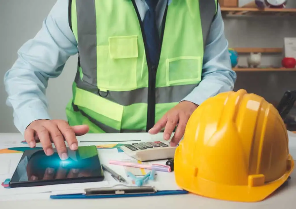 Architect or engineer using tablet to work on table